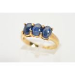 A 9CT GOLD THREE STONE SAPPHIRE CABOCHON RING, designed as three oval sapphire cabochons within claw