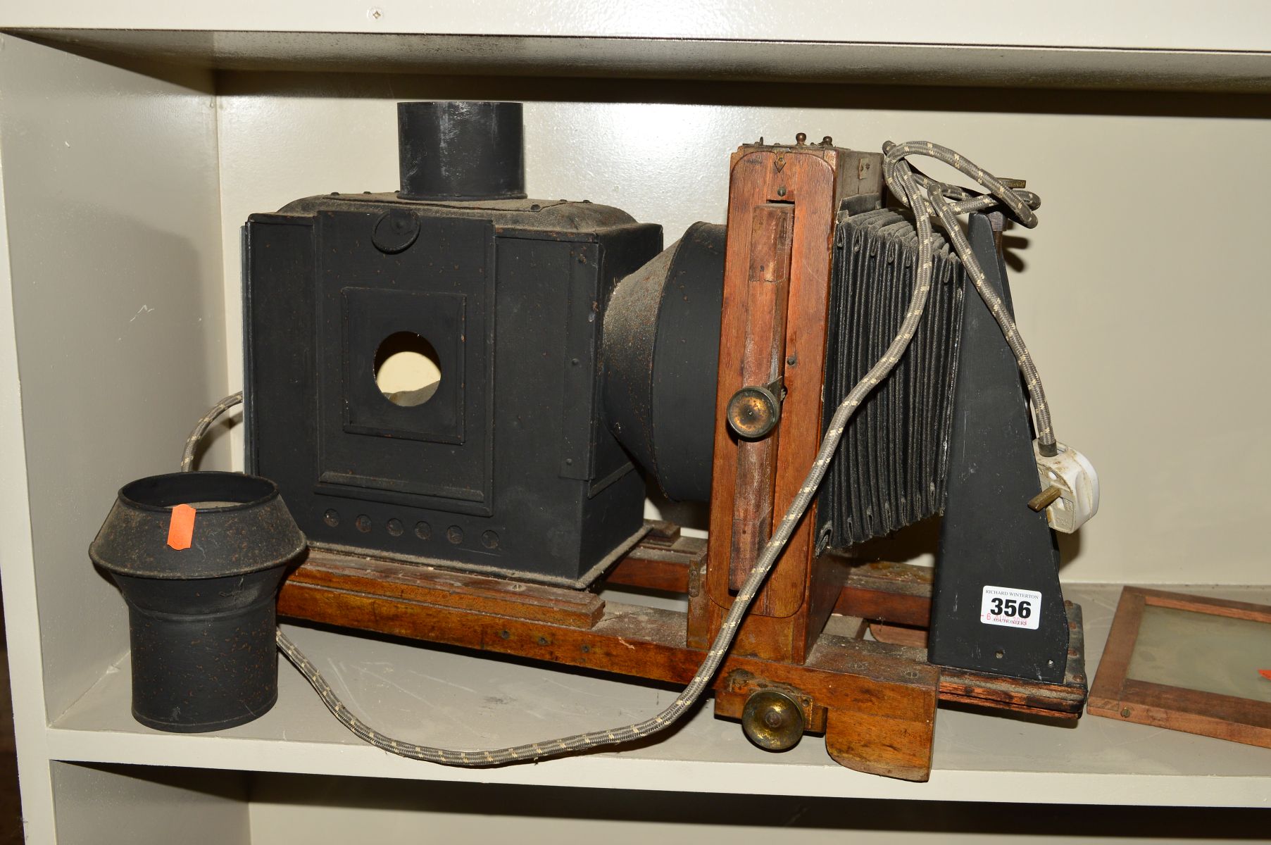 A TINPLATE AND WOOD MAGIC LANTERN, fitted with a Carl Zeiss Jena Tessar 13.5cm f4.5 lens, a standard