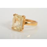 A CITRINE RING, designed as a rectangular citrine within a double four claw setting to the plain