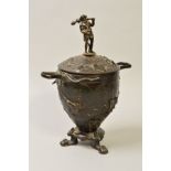 A BRONZE TWIN HANDLED URN AND COVER, of Victorian style, inscribed 'CAIN' to lower body, on three