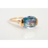 A 9CT GOLD COATED TOPAZ AND DIAMOND RING, designed as an oval coated topaz, the open shoulders set