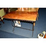 A RECTANGULAR HARDWOOD TOPPED TABLE, with a Gothic apron on a shaped wrought iron base, width