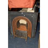 A VINTAGE BLACK PAINTED CAST IRON FIRE SURROUND WITH GRATE