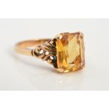 A CITRINE RING, designed as a rectangular citrine within a four claw setting with scrolling detail