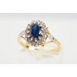 A SAPPHIRE AND DIAMOND CLUSTER RING, designed as a central claw set oval sapphire within a single