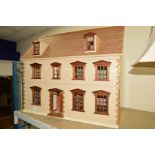 A MODERN DOLL'S HOUSE OF GEORGIAN STYLE, hinged roof and front, approximate width 96cm x height 85cm