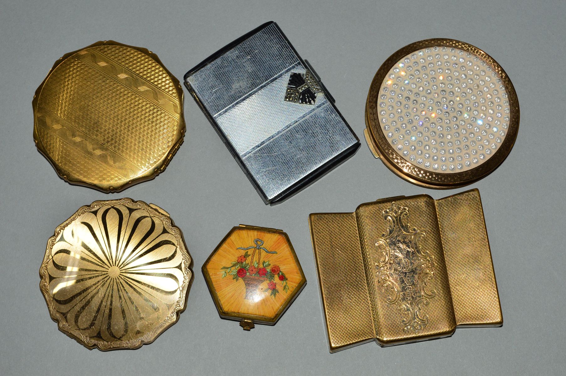 SIX VINTAGE COMPACTS, to include a personalised Volupte compact, two circular Stratton compacts, a