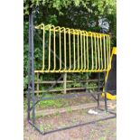 A TALL DISPLAY STAND WITH 18 YELLOW D SHAPES SECTIONAL BARS, (black and yellow) , height 300cm x