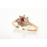 A 9CT GOLD RUBY AND DIAMOND CLUSTER RING, designed as a central circular ruby within a single cut