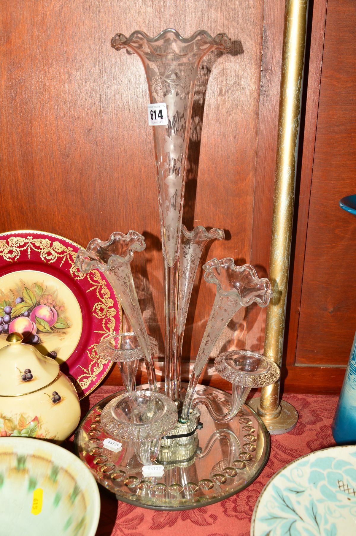 AN EPERGNE, with mirrored base, having central flute with etched vine detail, three matching smaller