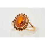 A 9CT GOLD CITRINE RING, designed as an oval citrine within a millegrain setting and double rope