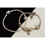 TWO PANDORA CHARM BRACELETS, suspending a total of seven charms to include various heart shape