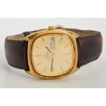 A GENTLEMANS QUARTZ OMEGA WRISTWATCH, the gold coloured face with baton markers, day and date