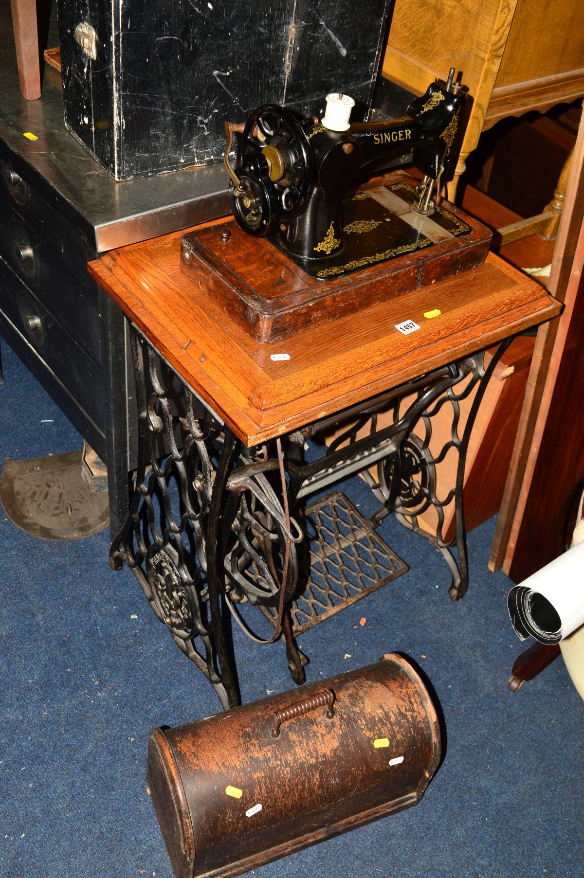 A SINGER TREADLE SEWING MACHINE with a golden oak top together with an oak cased Singer sewing