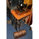 A SINGER TREADLE SEWING MACHINE with a golden oak top together with an oak cased Singer sewing