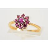 A RUBY CLUSTER RING, circular rubies within a claw settings, stamped 18ct, ring size K,