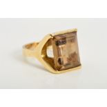 A 9CT GOLD SMOKY QUARTZ RING, designed as a rectangular smoky quartz within an abstract setting with