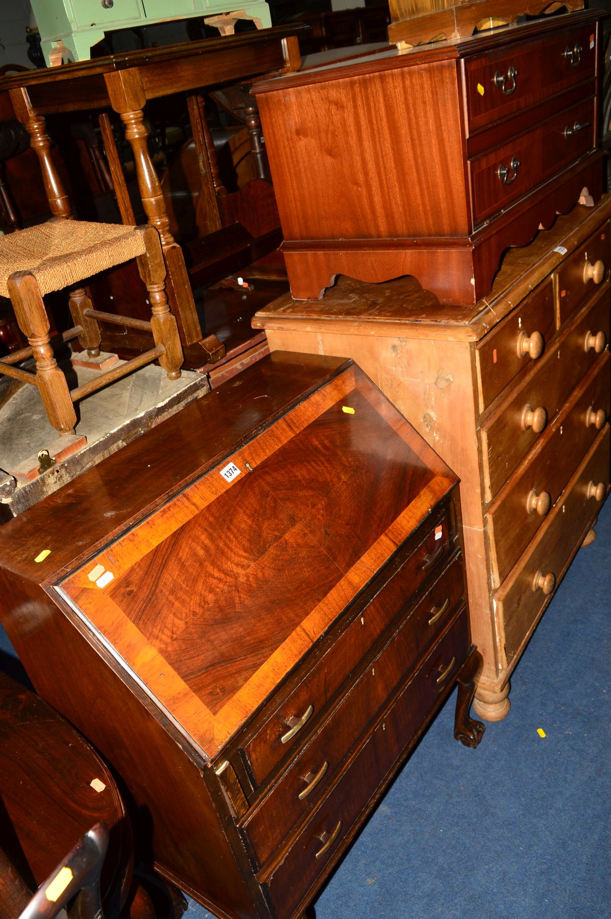 AN EDWARDIAN MAHOGANY AND WALNUT FALL FRONT BUREAU and a mahogany TV stand (2)