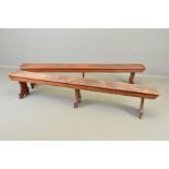 A PAIR OF VICTORIAN OAK LOW TRESTLE STYLE BENCHES IN THE MANNER OF EDWARD WELBY PUGIN (1834-1875),