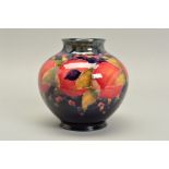 A WILLIAM MOORCROFT VASE, of bulbous form, decorated with pomegranate design, underglaze green