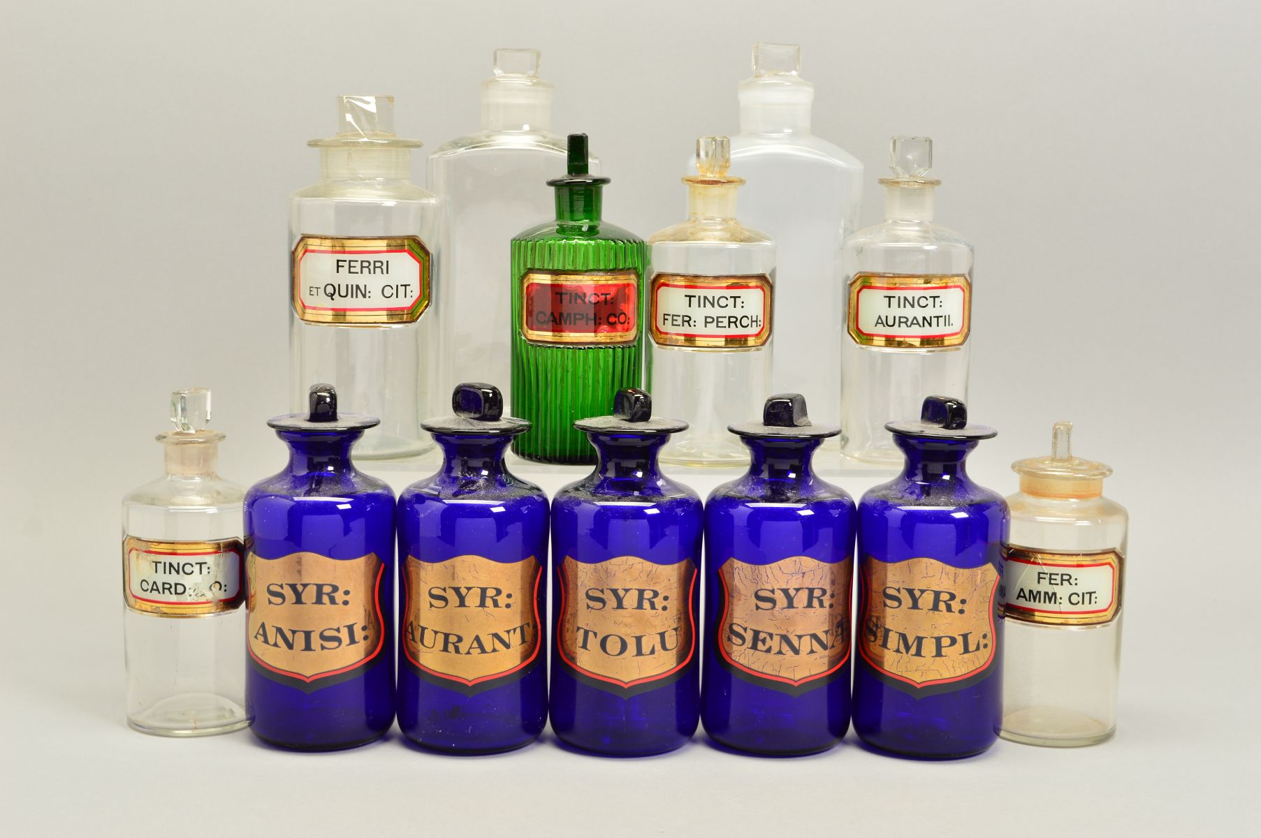 A SET OF FIVE 20TH CENTURY BLUE GLASS PHARMACY JARS AND STOPPERS, each with a gilt cartouche with