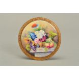 A STEFAN NOWACKI CIRCULAR PORCELAIN PLAQUE, painted with a still life of fruits, flowers, bird and