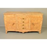 AN ART DECO BURR WALNUT SIDEBOARD, lipped top flanked by shaped front corners, central breakfront