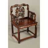 A LATE 19TH CENTURY CHINESE HARDWOOD ELBOW CHAIR, the serpentine back with pierced scrolling