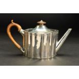 A GEORGE III SILVER TEAPOT, of fluted oval form, fruitwood finial and handle, the domed cover