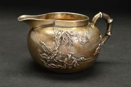 A LATE 19TH CENTURY CHINESE SILVER CREAM JUG, of rounded form, bamboo style handle, the body with