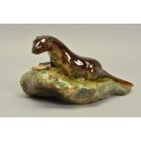 A RARE ROYAL DOULTON EARTHENWARE OTTER WITH FISH ON A RIVERBANK, possibly a prototype, glazed, bears