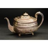 A GEORGE III SILVER TEAPOT, of rounded rectangular form, later foliate repousse decoration, on