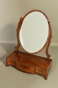 A GEORGE III MAHOGANY TOILET MIRROR, with satinwood and ebony banding, oval mirror on scrolled