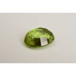 AN OVAL MIX CUT PERIDOT, measuring approximately 12mm x 8mm, weighing 3.88ct