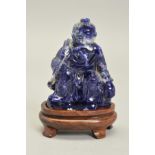 A HAND CARVED ORIENTAL SODALITE PIECE, oriental carving designed into an old man fishing, on top a