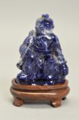 A HAND CARVED ORIENTAL SODALITE PIECE, oriental carving designed into an old man fishing, on top a