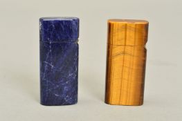 TWO CARVED STONE FLIP CIGARETTE LIGHTERS, one quartz tiger eye and one sodalite, measuring