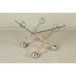 EICHHOLTZ, a square bevelled glass topped occasional table, on a separate stainless steel X shaped