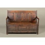 AN 18TH CENTURY OAK SETTLE, the four panelled rectangular back with bowed arms on block end