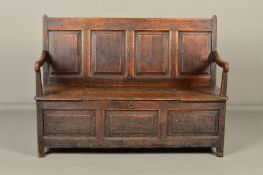 AN 18TH CENTURY OAK SETTLE, the four panelled rectangular back with bowed arms on block end