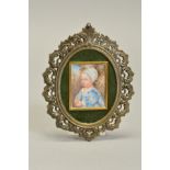 AFTER VAN DYCK, an early 20th Century portrait miniature of a young child holding a piece of