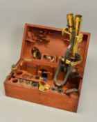 A LACQUERED BRASS BINOCULAR MICROSCOPE BY HENRY CROUCH OF LONDON NO.1188, in a fitted walnut case