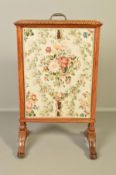A LATE VICTORIAN WALNUT FIRE SCREEN, of rectangular form, fitted with a central gilt metal handle