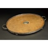 A LATE VICTORIAN SILVER MOUNTED OVAL OAK TWIN HANDLED GALLERY TRAY, the oak with oval silver