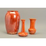 THREE PIECES OF RUSKIN STUDIO POTTERY, in the orange lustre glaze, comprising a 131 pattern vase,