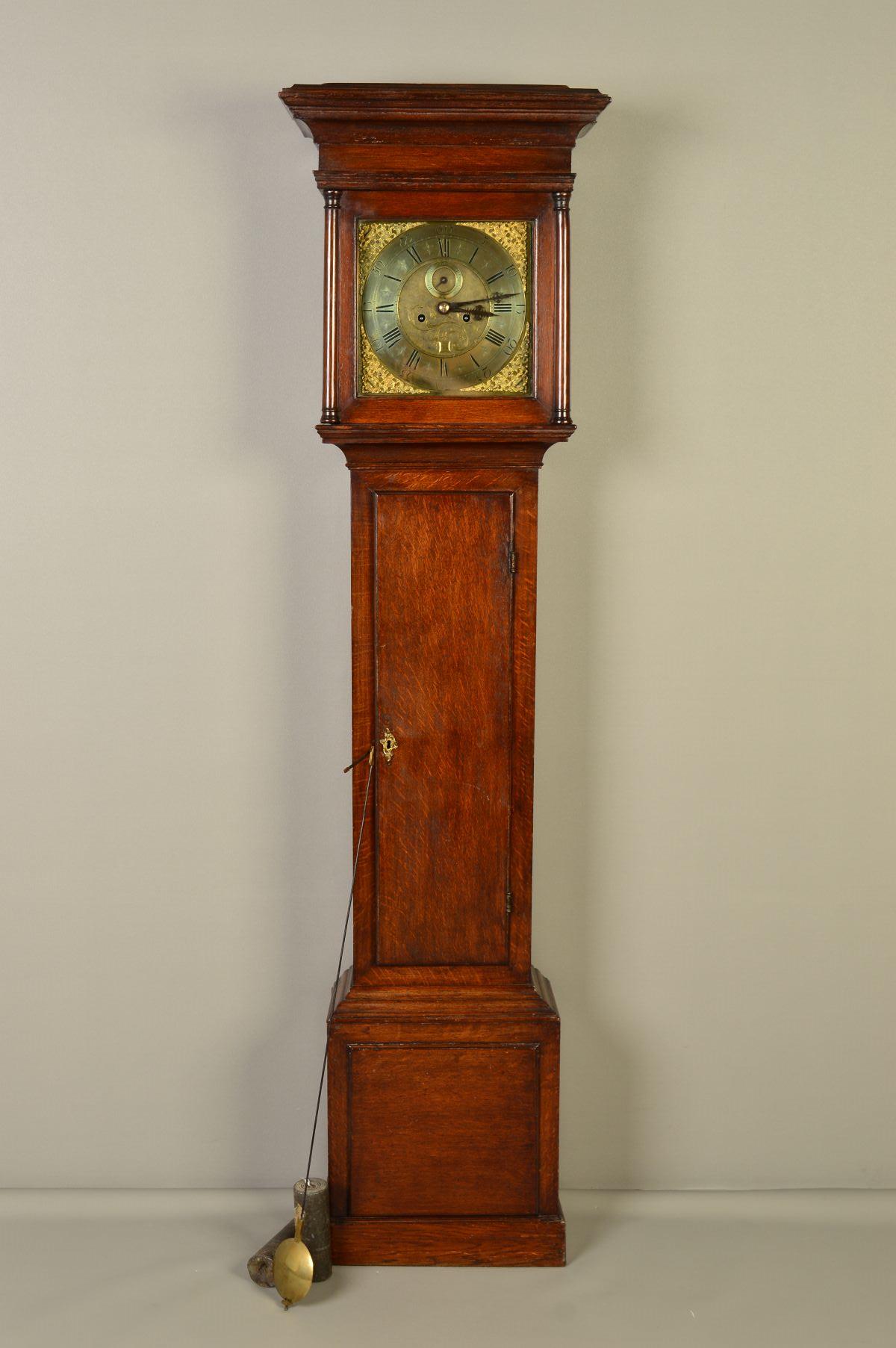 A GEORGE III OAK LONGCASE CLOCK, moulded pediment above the hood door flanked by half doric columns,