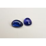 TWO OVAL CABOCHON SAPPHIRES, deep blue in colour, one measuring approximately 7mm x 5mm, second