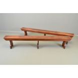 A PAIR OF VICTORIAN OAK LOW TRESTLE STYLE BENCHES IN THE MANNER OF EDWARD WELBY PUGIN (1834-1875),