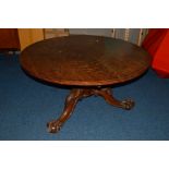 A VICTORIAN OAK CIRCULAR TILT TOP BREAKFAST TABLE, the edge above a single groove above eight slides