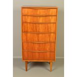 AUSTINSUITE, a tall teak chest of six graduating drawers with scalloped handles, on cylindrical